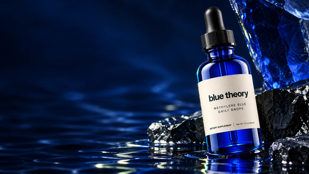 Blue Theory daily drops on cobalt glass and dark mineral stone